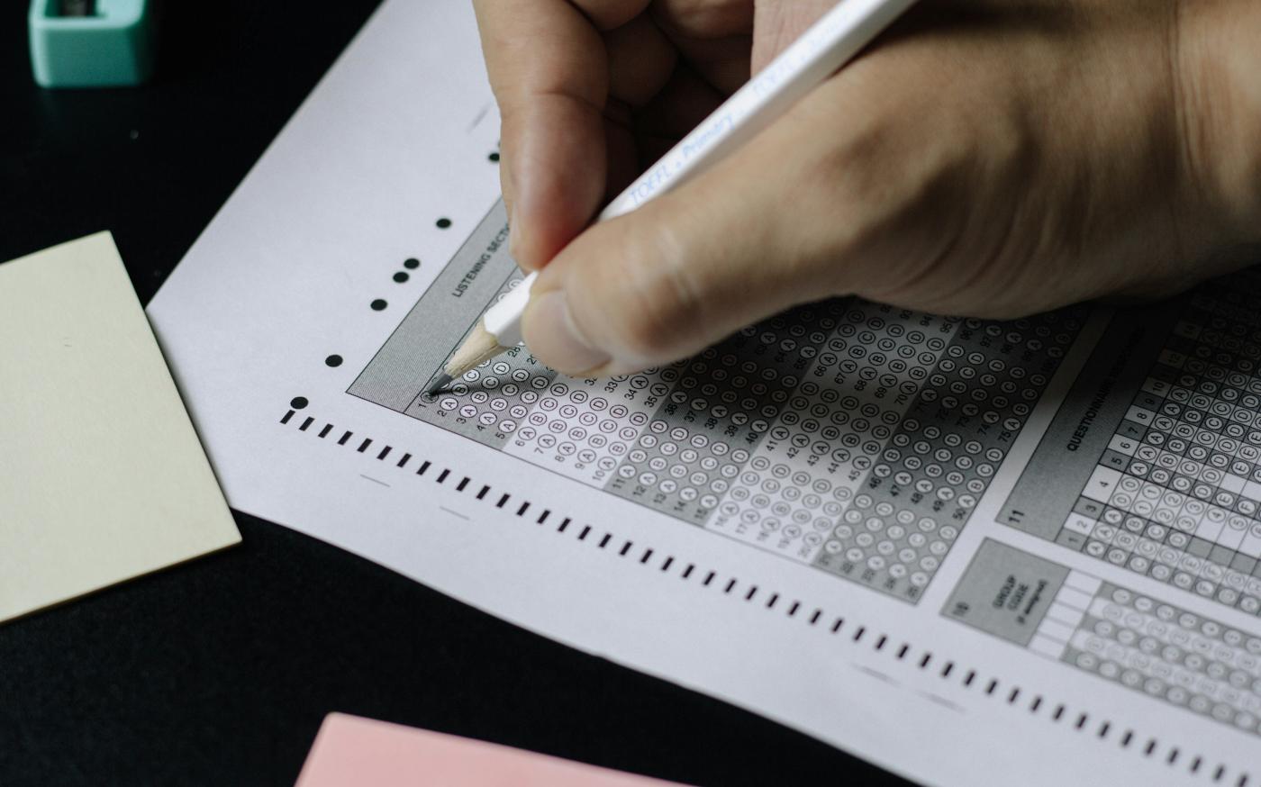 person writing on white paper by Nguyen Dang Hoang Nhu courtesy of Unsplash.