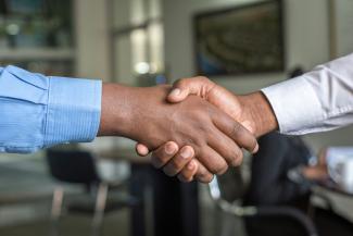 two people shaking hands by Cytonn Photography courtesy of Unsplash.